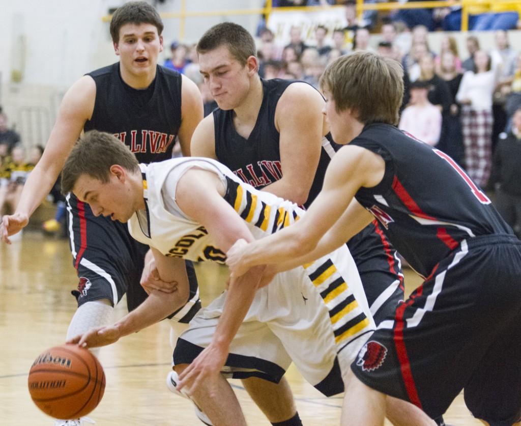 Photo by Keith Stewart Sullivan’s Nick Frerichs (left) and Kaleb Shumard (right) grab onto Tommy Watson in desperation during the final minute of Friday’s matchup in Tuscola. Watson’s four free throws in the fourth quarter were part of Tuscola’s 7-of-7 from the line.