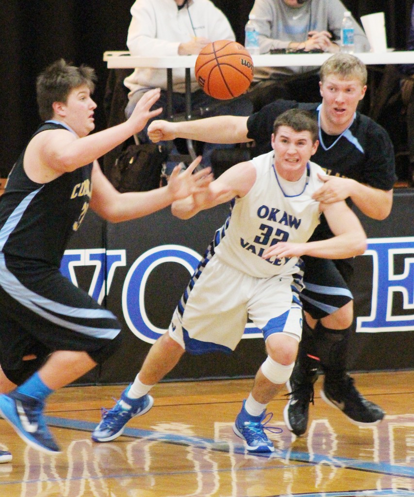 Photo by RR Best Okaw Valley’s Joe Jeffers tries to fend off two Cumberland players for the rebound Friday night.