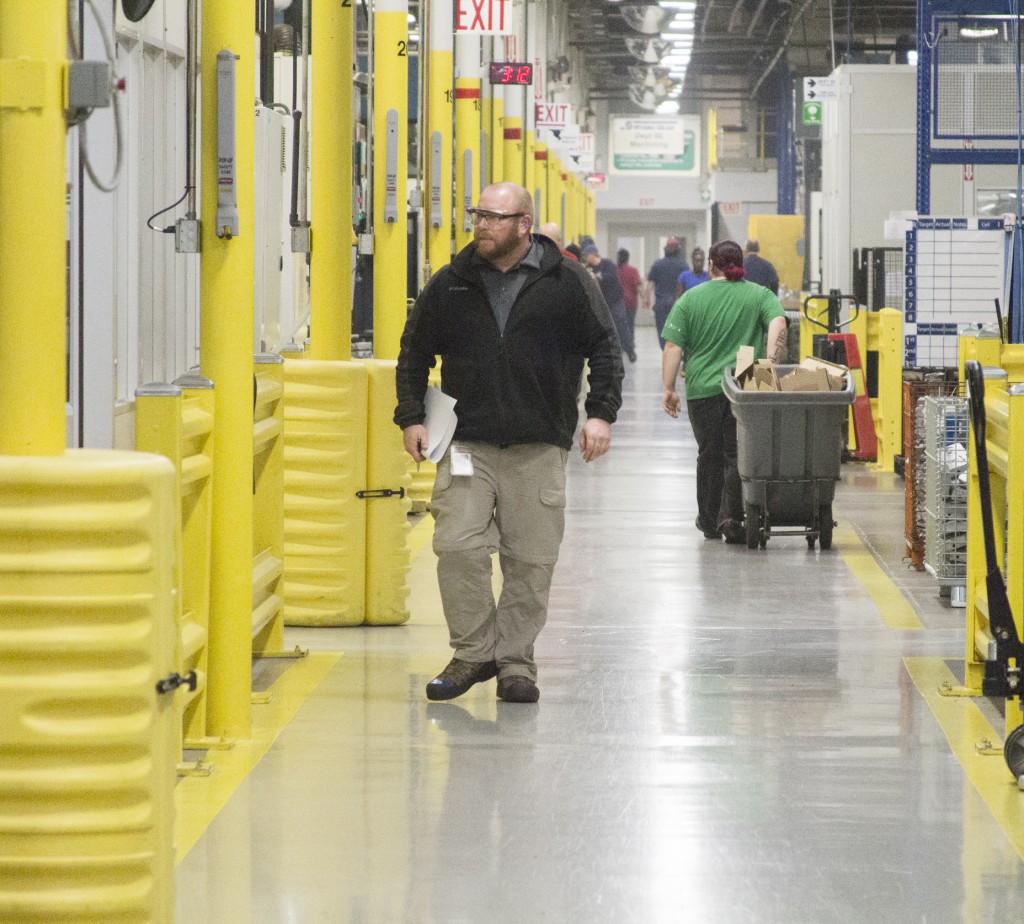 Photo by Keith Stewart Applications engineer Tom Gavin walks down a busy isle at Hydro-Gear Friday, February 6.