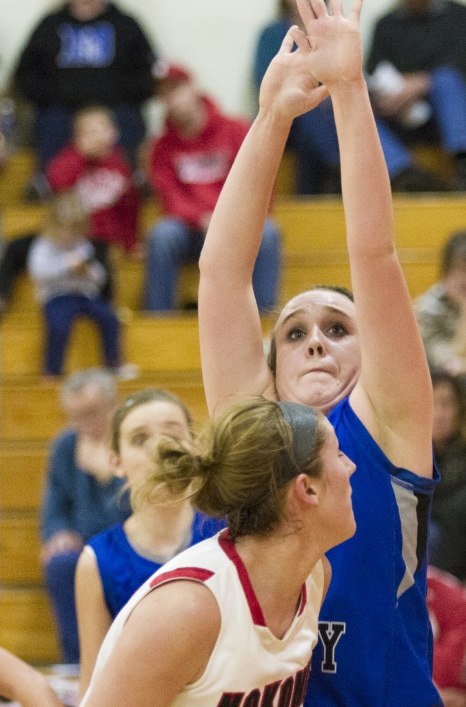 Photo by Keith Stewart Okaw Valley’s Jessica Robinson tries to stand tall against Nokomis’ Ashley Schneider last Wednesday. Between Robinson and Natalie Jeffers, Schneider still scored 24 points in the regional semi-final victory over OV.