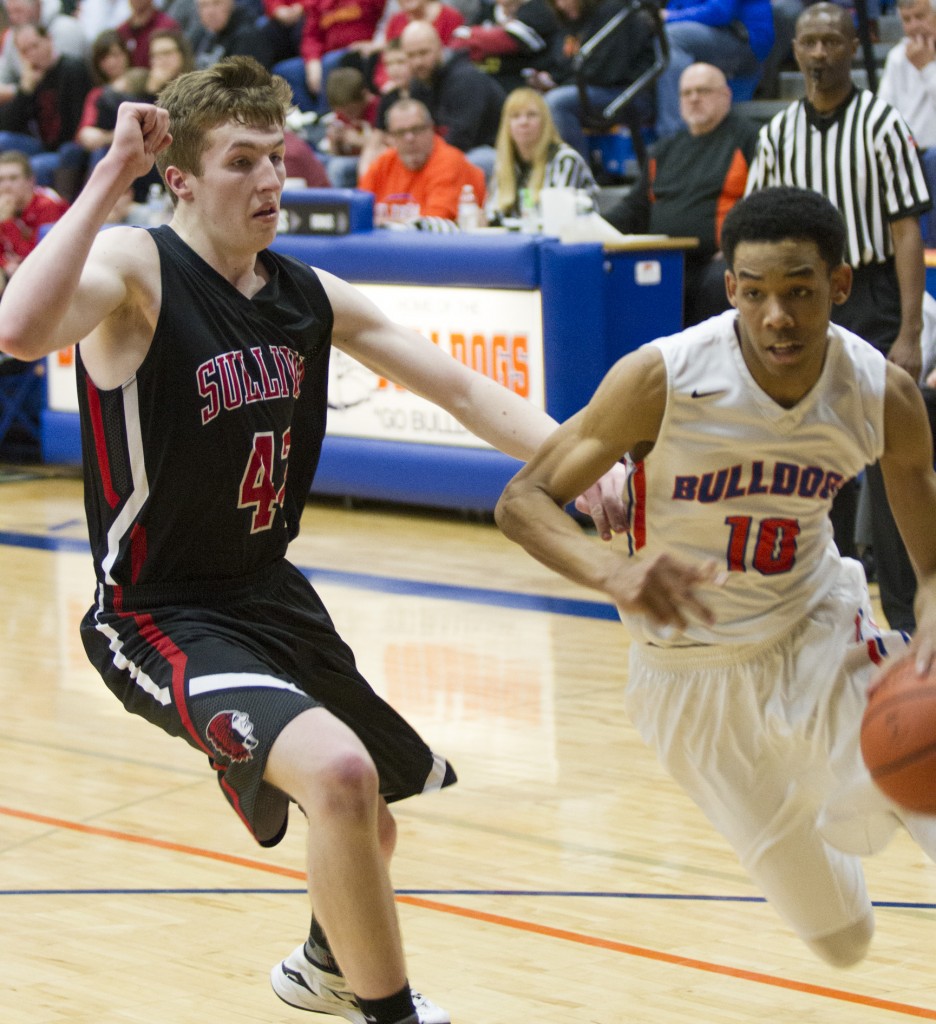 Photo by Keith Stewart St. Teresa’s Christian Williams drives past Layne McMahon Tuesday evening. Williams finished with 24 points, 10 of which came in the final period.