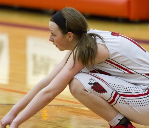 Photo by Keith Stewart Brittin Boyer sits crouched watching T-Town enjoy their regional title plaque last Thursday. Boyer was held to 10 points in Sullivan’s season-ending 56-54 loss.