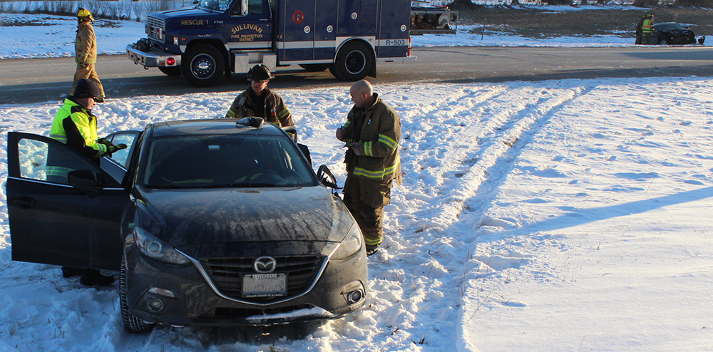 Photo by RR Best Emergency personnel are seen next to a 2015 Mazda passenger car  belonging to Amanda Kent of Charleston, who was pronounced dead at the scene after her vehicle was struck while parked on the shoulder of Illinois Route 121 Friday morning. In the background is the 2006 Cadillac SUV that was driven by Ame Shelton of Decatur that collided with Kent.