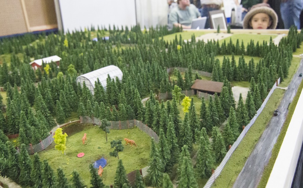 Photo by Keith Stewart A small boy eyes a 1:220th scale of the proposed Aikman Wildlife Park at the Arthur Outdoor Expo last month. There, Arthur resident James Aikman and his staff presented his proposed zoo to the public. 