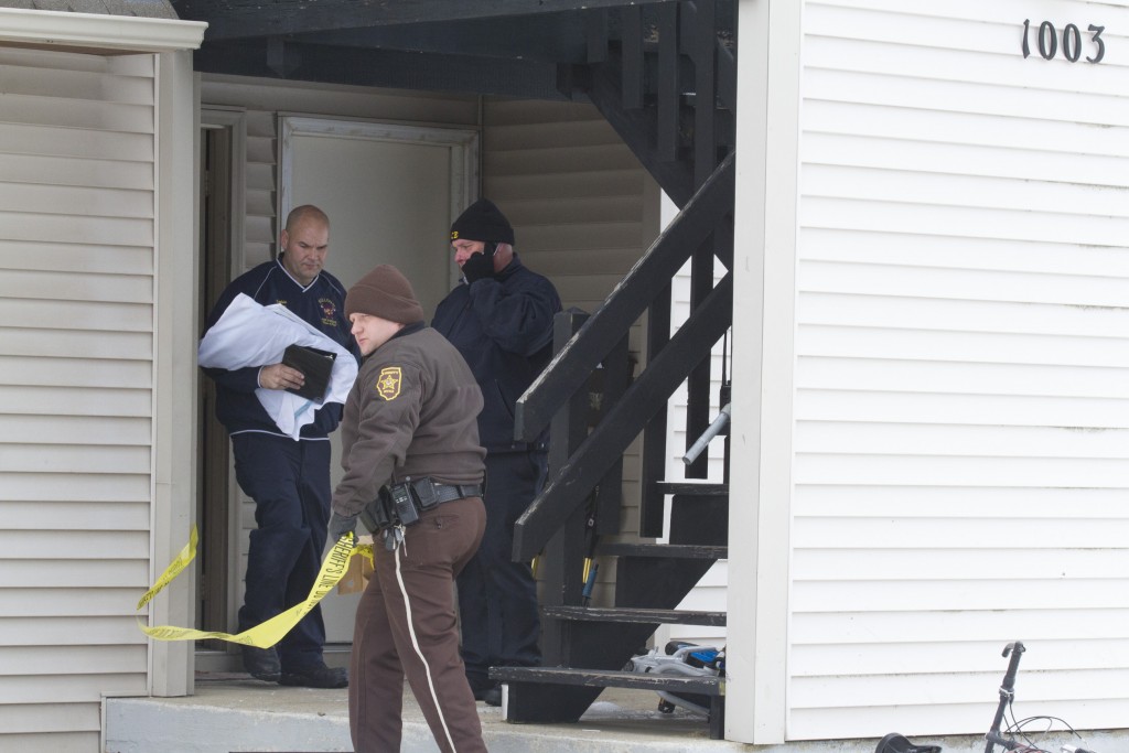 Photo by Keith Stewart Moultrie County deputy Gary Eller tapes off an area around an apartment in Sullivan Wednesday morning after law enforcement discovered what they are calling an apparent homicide.