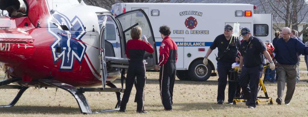 Photo by Keith Stewart Sullivan paramedics are seen transporting a juvenile to a medevac helicopter Monday afternoon in Arthur after the boy fell from the third floor of the Moultrie County Courthouse in Sullivan.