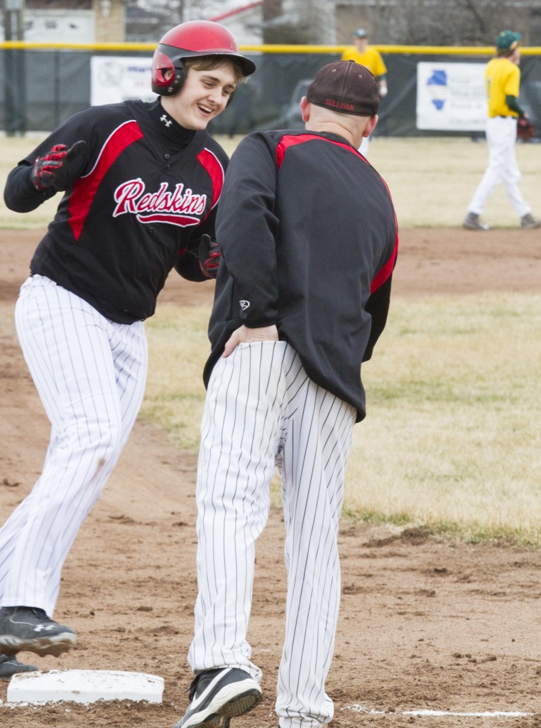 Photo by Keith Stewart Brody Elder rounds third and is greeted by head coach Troy Rogers after hitting a home run in just the second at-bat of the game that put Sullivan up 1-0.