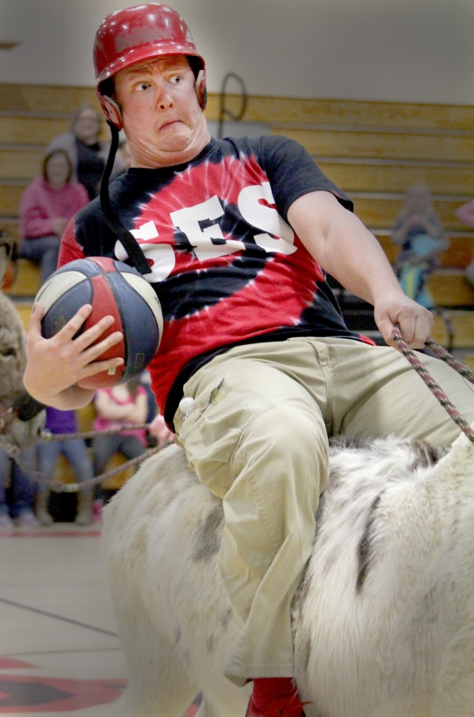 Photo by RR Best Trying to Hold On Sullivan Elementary teacher Scott England tries to hold on to the reins Monday, March 23 during donkey basketball hosted by the Sullivan Elementary School PTO.