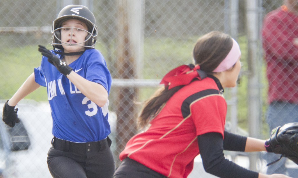 Photo by Keith Stewart Okaw Valley freshman Paige Robinson tries to beat out the throw to first baseman Emily Seegmiller Monday.