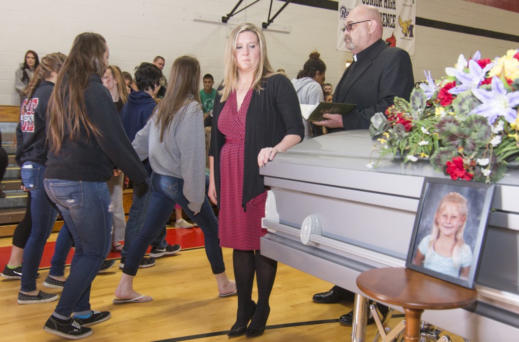 Photo by Keith Stewart Sullivan high school students walk by the casket of a crash victim as the mother, played by SHS social studies teacher Marsha Kirby and pastor Bil Reedy look on solemnly. Though pretend, the casket and actors were part of last Thursday’s very serious presentation on the perils of both drunk driving and texting and driving.