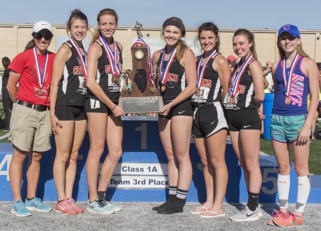 Photo by Keith Stewart Pictured, from left to right, are members of the SOV girls’ track and field team with their third place team trophy at the IHSA state track meet Saturday in Charleston: Head coach Kali Taylor, Ashlynd Risley, Amanda McClain, Emily Neuhauser, Carlin Nuzzo, Bailey Turnbaugh, and Abby Cravatta.