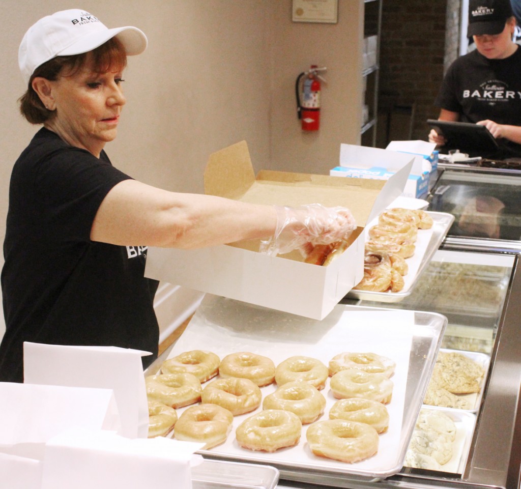 Photo by RR Best JoBeth Risley is seen boxing up fresh glazed doughnuts early Friday morning. After first opening last Thursday, the Sullivan Bakery has sold out of its goods every day since.