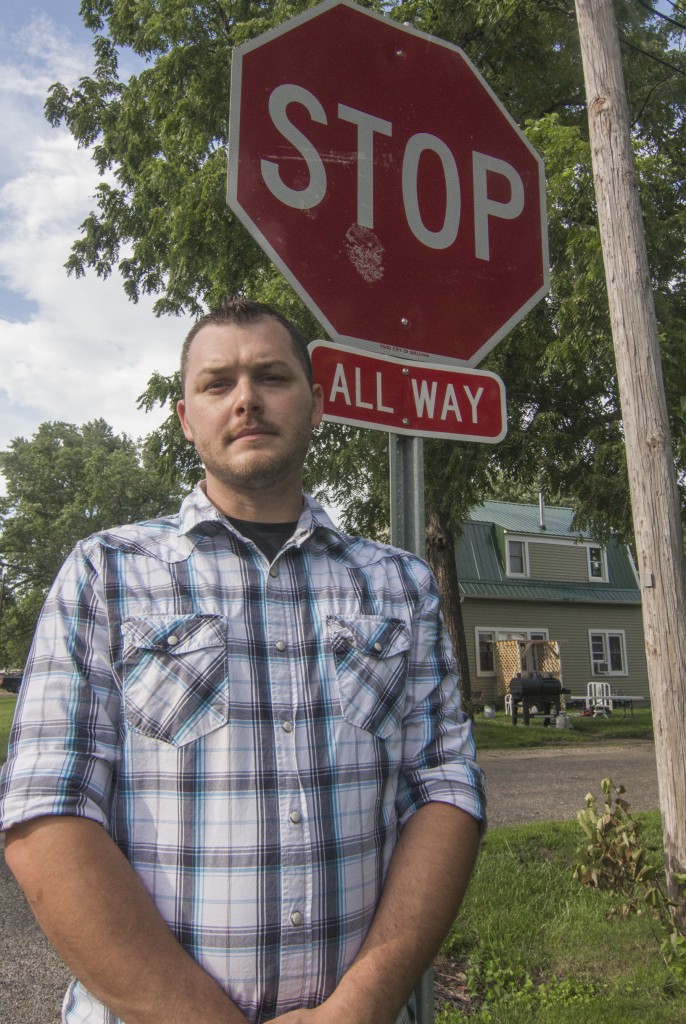 Photo by Keith Stewart Sullivan resident Tyler Wagey stands in front of a newly installed 4-way stop-sign at the intersection of Washington and Blackwood after he went to the city council with concerns about vehicles speeding throughout the neighborhood.