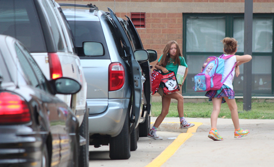 RR by Best photo First Day  Sienna Casteel grabs her bag and races to class to join Sullivan elementary school students on the first day. Sullivan went a full day on Aug 18. Elementary schedule is 8am to 3:05pm, Middle school is 8:14am to 3:15pm and High School is 8:14am to 3:15 daily.