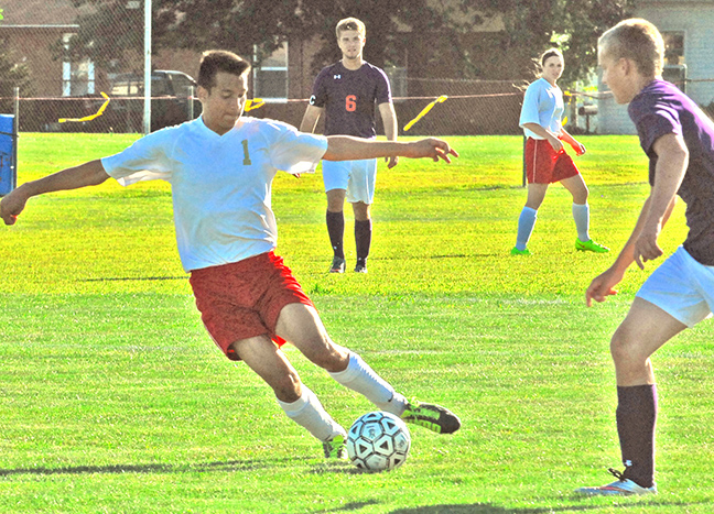 Photo by Mike Brothers Knights face Georgetown-Ridge Farm On Tuesday, Aug 25 the Arthur-Lovington Atwood-Hammond Knights hosted Georgetown-Ridge Farm at Lovington for their first match. Above Knight Eusebio Briseno maneuvers through Georgetown traffic on his way to the goal. Georgetown-Ridge Farm came out on top three goals to one in this first match for the Knights.