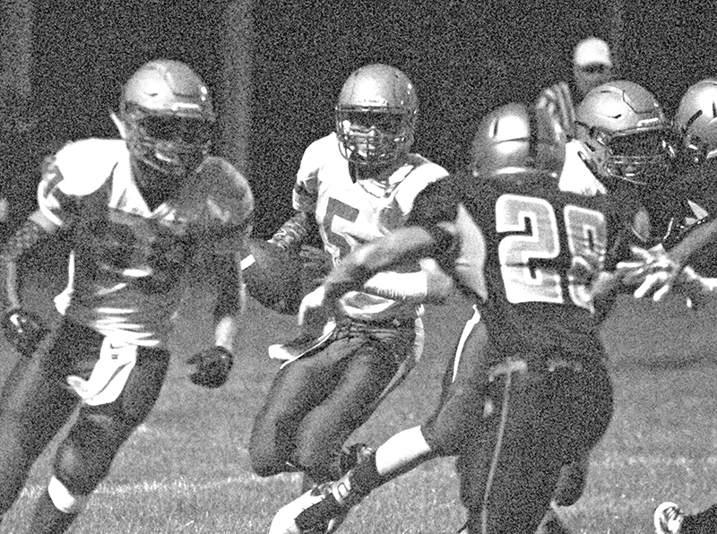 Photo by Mike Brothers Tyler Smith creates a path for quarterback Teddy Poe on an end run during the Sangamon Valley Storm ALAH Knight game Friday at Niantic.