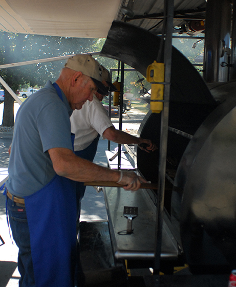 Photo by RR Best Celebrating 150 Years First Mid-Illinois Bank and Trust in Sullivan celebrated 150 years with a customer appreciation cookout Friday, September 25 from 11a.m. - 1 p.m. Above: caterer and cook Terry Warren flips pork burgers which were served bank customers free along with chips, cookies and drinks.