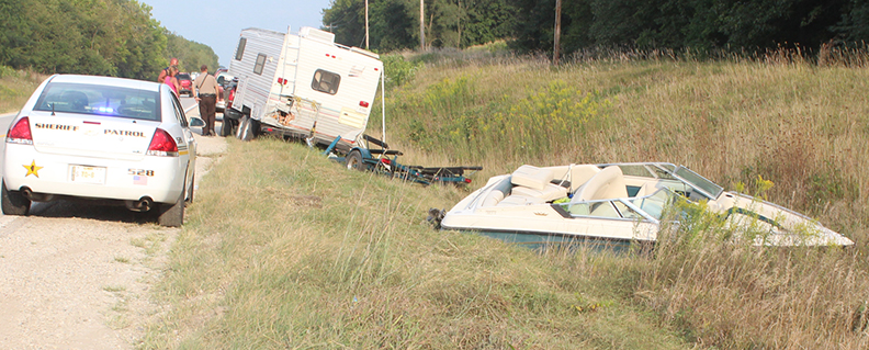 Photo by RR Best Chain reaction An Indiana couple was on their way home from Lake Shelbyville when the boat they were pulling went out of control; dragging the camper, the truck that was pulling it and the couple into a roadside ditch near the lake bridge on the Findlay Road. According to the Moultrie County Sheriff’s Department when Jason Burdge went over the bridge pulling the camper and boat, the truck bounced and the chain reaction led to the boat careening into the ditch while pulling everything else along. No one was injured and damage was limited to the Burdge vehicles. The driver was cited for failure to reduce speed to avoid an accident in the Monday afternoon accident. 