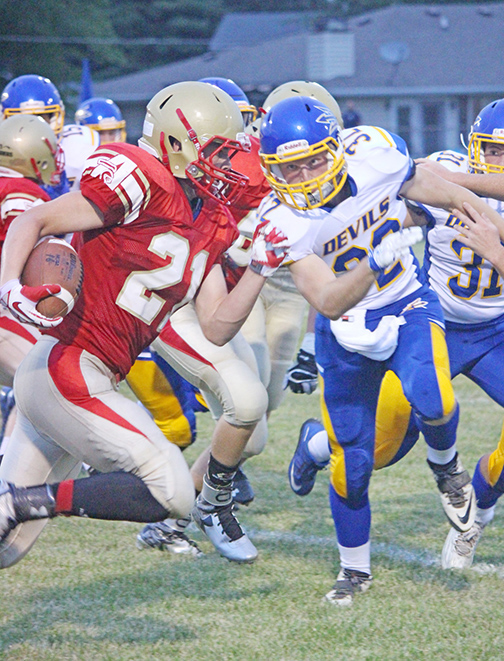 Photo by Darian Hays Knight running back Marcus Vanausdoll navigates through Villa Grove-Heritage traffic in Friday’s game at Arthur. Vanausdoll scored a touchdown and two point conversion for the evening.