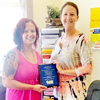 Photo Submitted C.E.F.S. Award Pictured (Left to Right) 2015 Family of Distinction Award recipient Serena Spencer receives plaque from C.E.F.S. Economic Opportunity Corporation’s Moultrie County Outreach Coordinator Kristy Dawson.