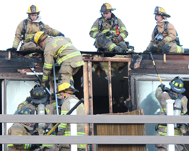 Photo by RR Best Apartment Fire Sullivan firefighters responded to a fire at the Graham Street apartments where flames had broken through a second story balcony. Fire investigator Kenny Graven said an estimated $10,000 fire damage was limited to the upstairs apartment with the cause undetermined. Searching for hot spots are: on roof from left Brock Read, Travis Hughes and Josiah Davidson; on ladder Adam Collins and on ground Kenny Graven, Kaleb Randall, Jason Fleming and Tyler Wright.