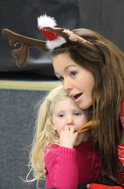 Photo by RR Best Sounds of the Season Tessa Welty holds Emmersyn Jiannoni while listening to the Sullivan Elementary and Middle schools’ holiday program which musically set the tone for the season. 