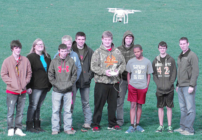 Photos by Mike Brothers With the Drone in the foreground the class learns how to maneuver. Pictured from left: Eric Mercer, Olivia Buxton, Conner Sheehan, Ethan Macklin, Kam Roley, Kyle Burford, T.J. Williams, Jackson Masters, Wesley Wise, ag instructor.