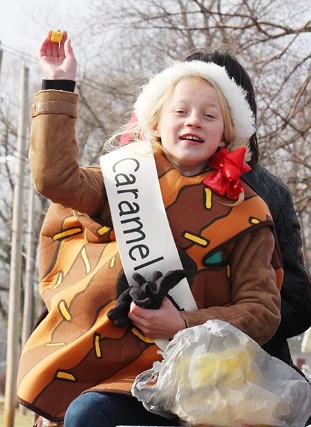 Photo by RR Best Sullivan Christmas Parade Kylee Ragsdale stays wrapped up for the cool ride in the Sullivan Hometown Christmas Parade last Saturday. Kylee encouraged the parade goers to brave the cold as she tossed candy to the crowd.