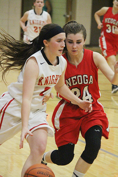 Photo by Darian Hays Lady Knight Mycaella Miller maneuvers around Neoga Indian Banning in the 82-74 win over Neoga last week. Miller finished the night with 11 points.