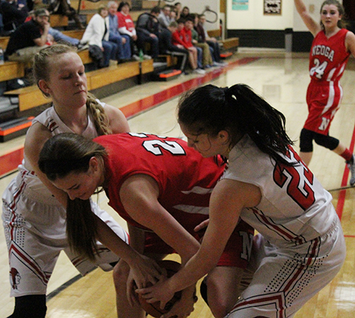 Photo by Mike Brothers The Lady Redskins were aggressive on the ball and rebounds during the Neoga game January 9.  Above Chloe Riley and Ester Miller made sure Neoga’s Jaycie Roy didn’t get away clean after a rebound. Miller and Riley contributed to the defensive effort on the floor and backboards. Miller scored seven of her nine points from the free stripe with Riley scoring three of her five points from the free throw line. 