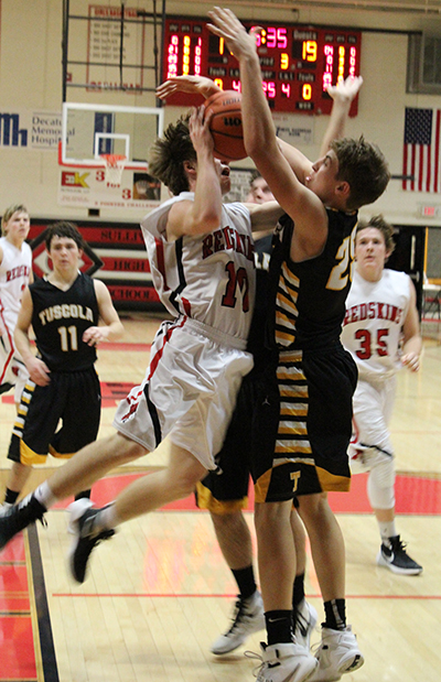 Photo by Mike Brothers Sullivan’s Kaleb Shumard drives hard to the basket in the January 8 home game against the Tuscola Warriors on the Redskin home court.