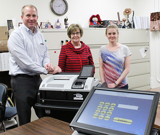 Photo Submitted New Voting Equipment: Liberty Systems LLC partner Ken Gibson, County Clerk Georgia England and Election Deputy Jamie Helton prepared the system for operation last week.