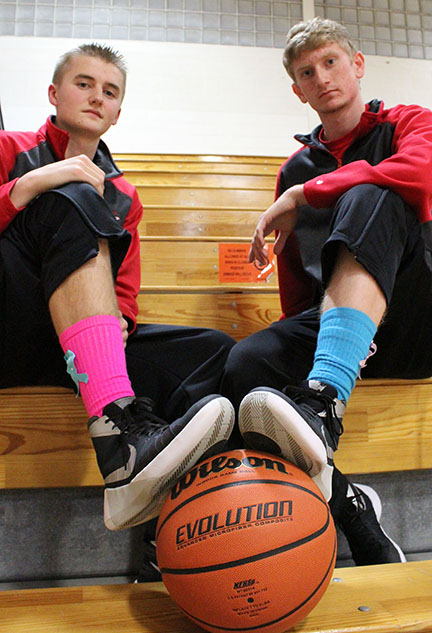 Photo by Mike Brothers Adam White and River Edwards were joined by the Sullivan Redskins basketball team wearing pink and teal socks with ribbons to honor those fighting breast and cervical cancer.