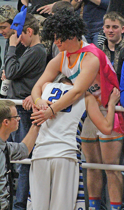 Photo by RR Best Okaw Valley senior Alex Martin is comforted by Super Timberwolf fan.