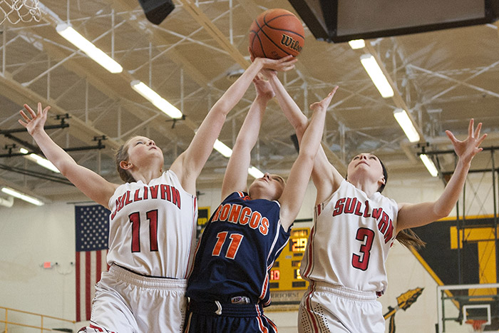 Photo by Doug Cottle Sullivan Lady Redskins Madi Wall and Alyssa Marshall take rebound from Bronco in the 43-40 regional loss in Tuscola Monday.