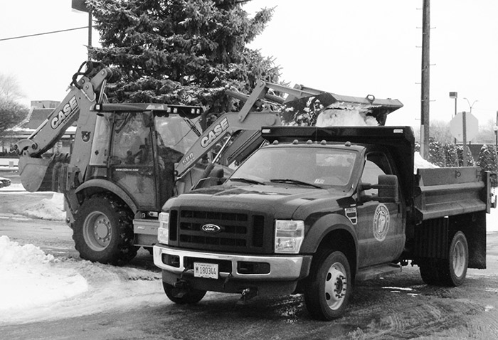 Snow Goes City of Sullivan Street Department crews scoop the piles of snow left over following the Valentine’s Day weekend accumulation.