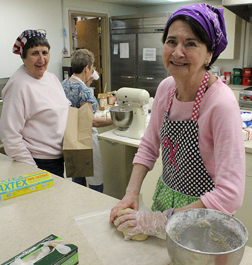 Photo by Mike Brothers Golden Eggs For 27 years volunteers from the First United Methodist Church in Sullivan diligently turn out peanut butter and vanilla eggs, preparing some 400 Easter baskets for delivery to lucky sweet lovers throughout Moultrie County. There are about 40 volunteers working shifts to complete orders before Easter. Above Karen Dwyer prepares another batch of peanut butter fudge with Lucy Hilliard (center) shuttling ingredients to mixer Fern Patton in the background.