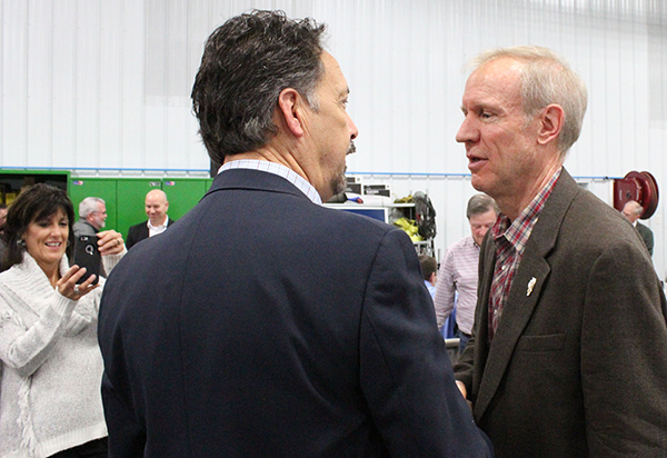 Photo by Mike Brothers Crowd meeter- Governor Bruce Rauner (right) greeted Moultrie County Lincoln Day guests following his remarks Saturday at Terry Warren’s farm.  Above Rudy Huber from CF&H in Sullivan has a few words with the governor while wife Linda snaps a cell shot as a momento.