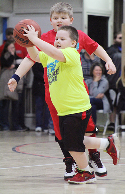 Photo by RR Best Mighty Mites Basketball Mighty Mites basketball player Aiden Burgess (above) looks for someone to pass the ball to during Sullivan action last weekend. The introductory  program for 5-8 year olds teaches basic skills, team work and good sportsmanship.  