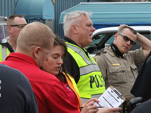 Photo by Mike Brothers Sullivan schools’ security Gary Eller and Kim Swinford of the Moultrie County Health Dept. review first responder checklist while Sullivan police chief John Love and Moultrie County chief deputy Gary Carroll go over rapid response procedures during  active shooter training March 9. 