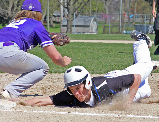 Photo by RR Best Timberwolves’ Austin Hill’s determination gets him to the bag just as the throw arrives in Okaw Valley’s win over Shelbyville.