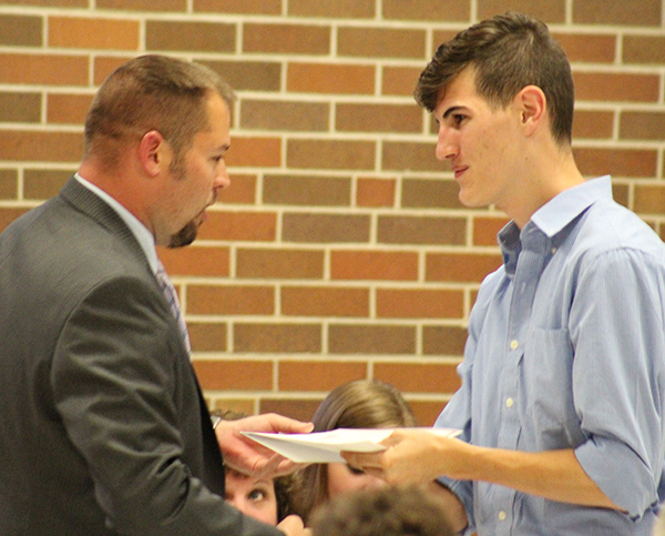 Photo by Mike Brothers Sullivan athletic director Ryan Aikman presents Blake Stewart with the L.J. Hollonbeck Memorial Track Scholarship.