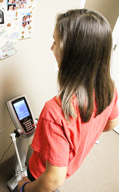 Photo by Mike Brothers Nutritionist Lindsey Shamloo stands barefoot on the InBody230 and holds her thumbs in the two wands for for two minutes. A complete body analysis is printed for review by a Physician’s Choice Wellness professional.