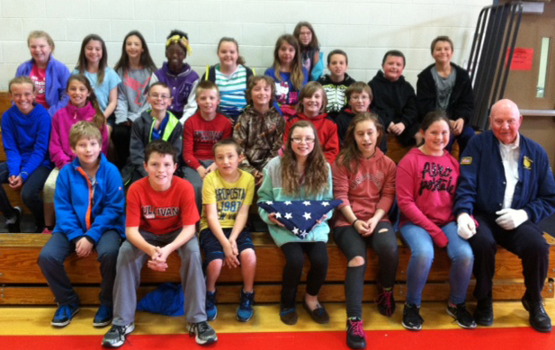 Photo furnished American Legion Post 68 Presents Flag Fifth graders at Sullivan Elementary school are in charge of raising and lowering the flag daily. When they noticed the flag was tattered and worn, Cheyenne Fleshner, a fifth grade student in Nichole Hendry’s class, wrote to the Sullivan American Legion and asked whether they would donate a new one. Less than a week later, Bob Sims of the Sullivan Legion, came to school and offered the flag to Cheyenne and thanked her for her letter. He then addressed the class and informed them of the Legion’s purpose to serve the community. He added that if they knew of anyone in need of new flags or other services the Legion offers, to write a letter with the request. Pictured are Hendry’s fifth grade class and Sims.