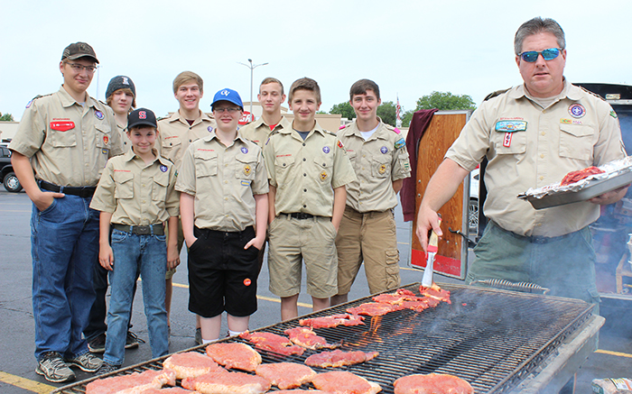 Photo by Mike Brothers Boy Scout Troop 39 Cook Out Sullivan townwide rummage sale shoppers had a chance to stop by the Sullivan IGA parking lot on June 3 and 4. Boy Scout troop 39 was offering delicious steak, pork chop and brat sandwiches giving busy shoppers a convenient lunch break. Troop 39 pictured preparing for lunch are back from left-Lake Atchison, Matthew Ellinger, Alex Menke, Khayman Van Loon, Seth Rice; front Beau Fleming, Seth Weaver and Laytin Pratt with Scoutmaster Jeff White manning the grille.