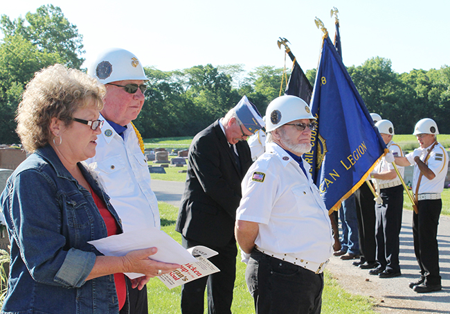 Photo by Mike Brothers Greenhill Cemetery Memorial Day program speaker Rita Florey expressed gratitude to those who have served. Post #68 Commander Bob Sims, Charles Bragg and the Honor Guard are in the background.