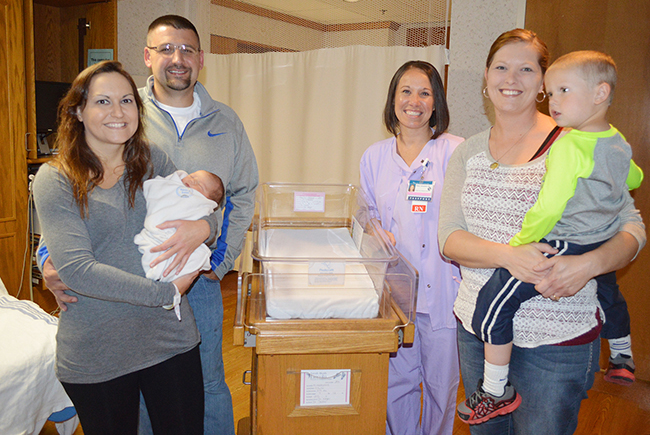 Photo furnished Newborn Kambri Hildebrand, with parents Brett and Mara Hildebrand, models a sleep sack at Sarah Bush Lincoln. They are pictured with SBL women and children’s nurse Haley Campbell (center) and Angie Goebel with her three-year-old son Grant.