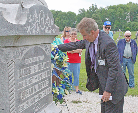 Photo by Mike Brothers DMH CEO and President Tim Stone places a wreath on Sue Hagaman’s grave.