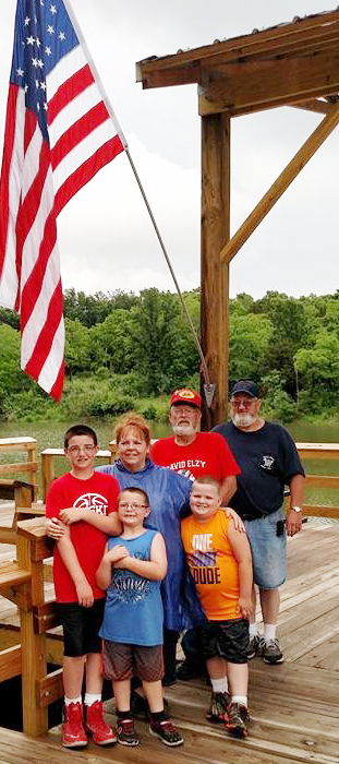 Photo by RR Best Woods Lake Reopens Saturday, June 4 marked the grand reopening of Woods Lake south of Sullivan. Above the Burgess family from Sullivan enjoys the new fishing pier and handicap accessible boat dock which completed the U.S.Corp of Engineers project with help from volunteers of Sullivan AmBucs and Lincoln Trail Council Boy Scouts and others. The 30 acre lake was drained and cleaned and restocked with select fish. Part of the ceremony Saturday included a kid’s fishing tournament, hot dog roast, boat rides, archery and BB gun shoots. A plaque listing partners in the project was put on display as part of the 2 p.m. ribbon cutting ceremony.