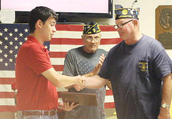 Photo by Darian Hays Lovington American Legion Commander George Clark (right) honors Aaron Fleming for his years of playing Taps for military rites, while Tom Brown Honor Guard coordinator looks on.  